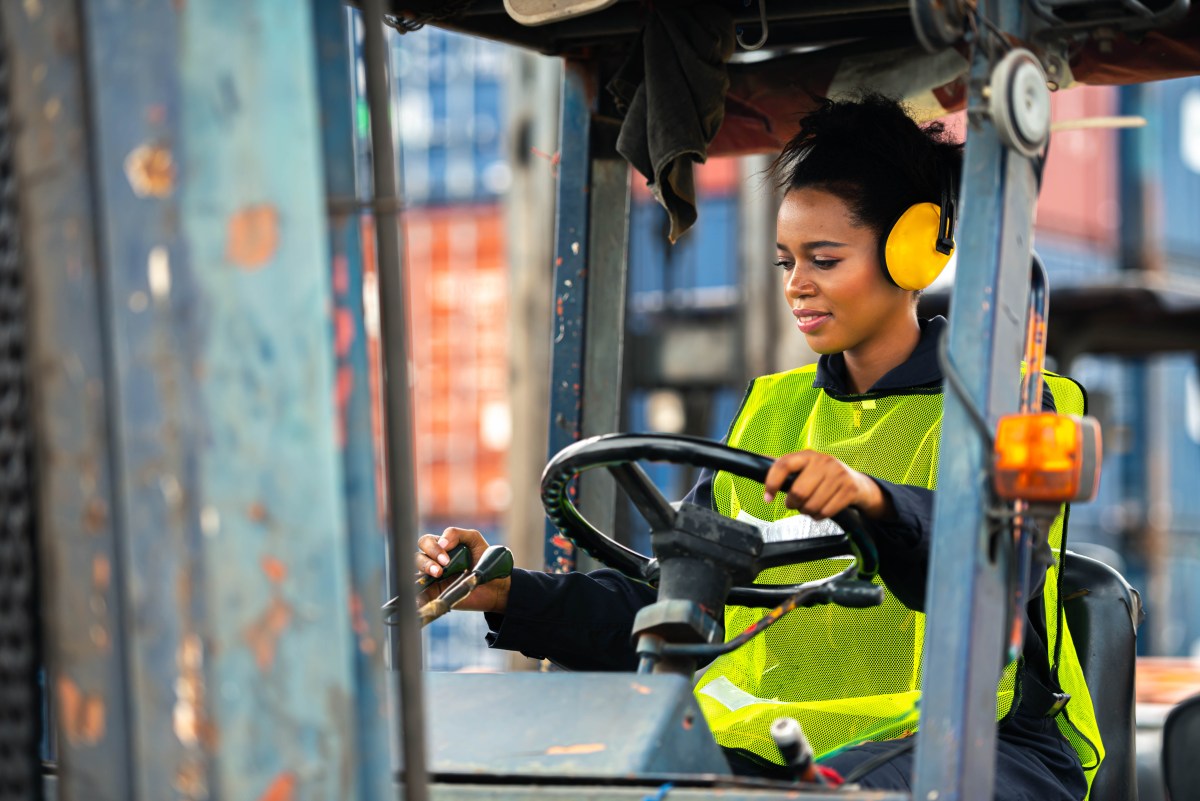 Forklift operator working in an industrial warehouse