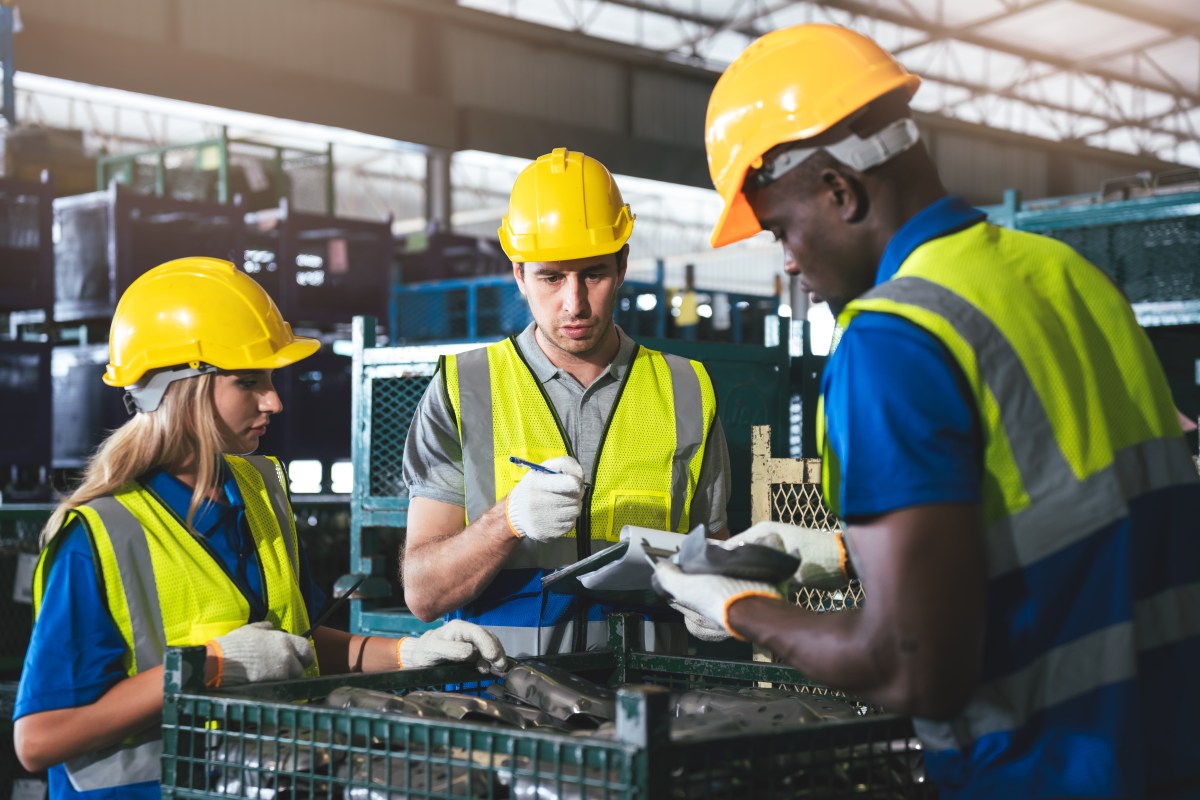 Warehouse quality-control team reviewing production work